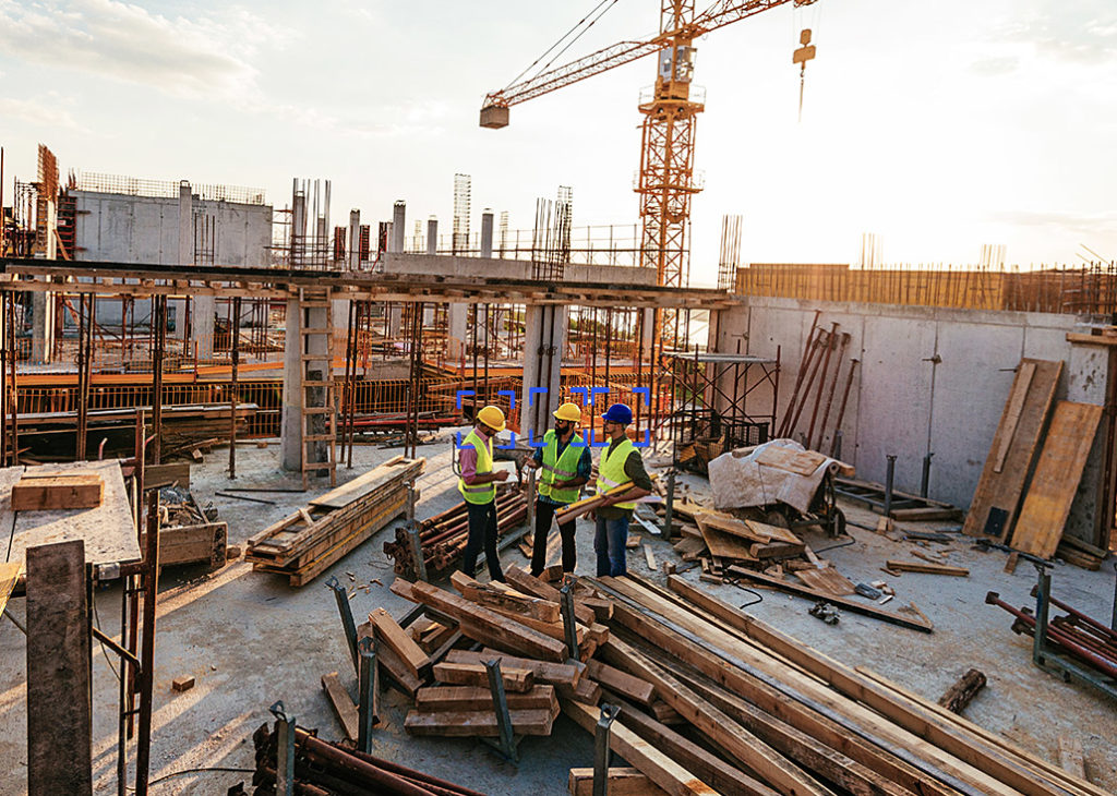 3 work men in a construction setting.